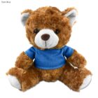 Brown teddy bear wearing a blue shirt, sitting against a white background.