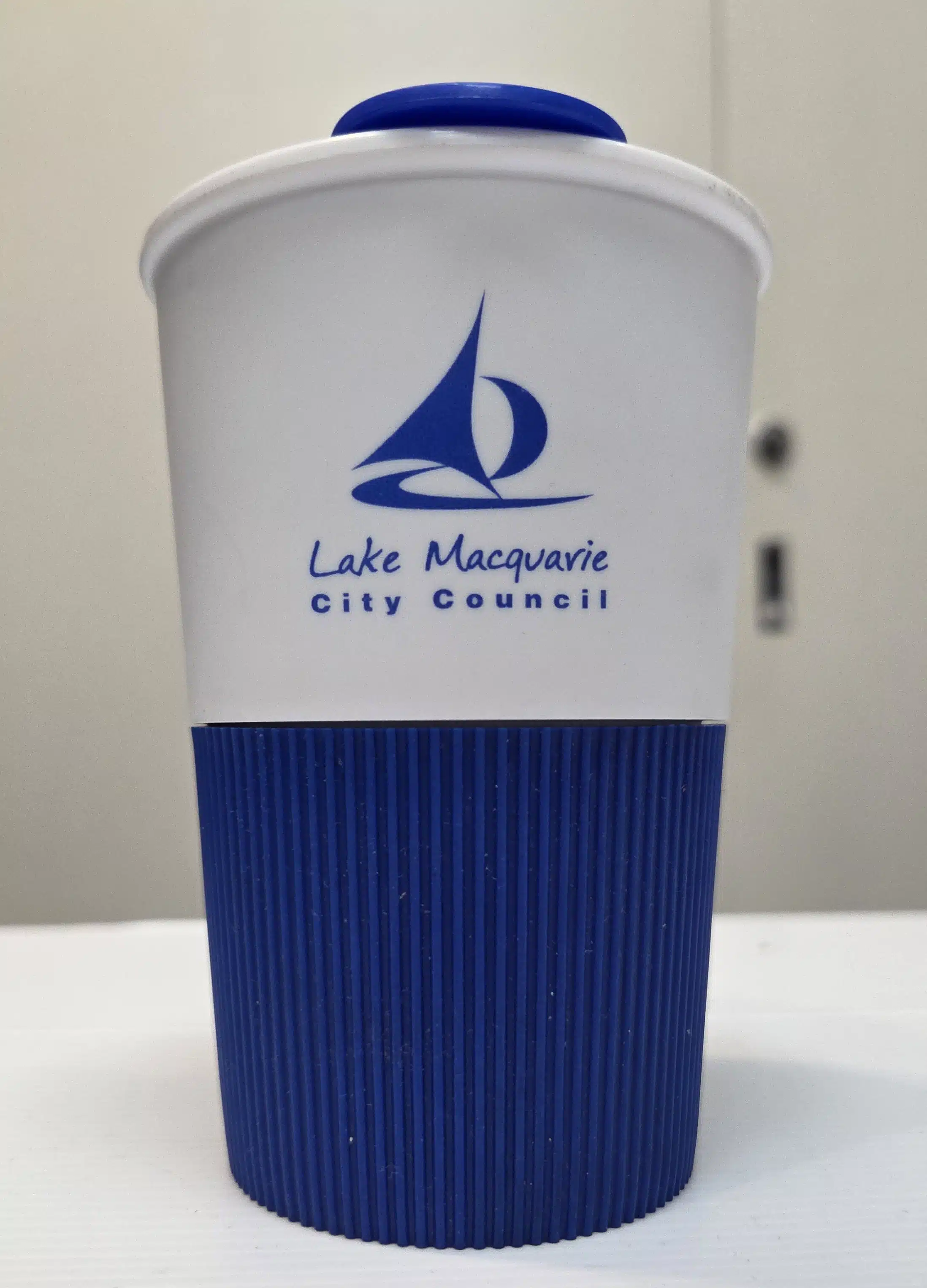 blue and white cup with logo