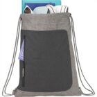Gray drawstring backpack with books and a white headphone visible inside.