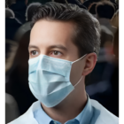 Man in a crowd wears Promotional Protective Face Mask Bulk Packs, looking to the right.
