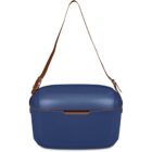 A blue, rectangular cooler with a brown shoulder strap.