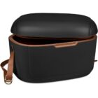 Black leather handbag with a brown strap and partially open lid.