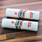 Standard Custom Glue Sticks adhere to wood, showing their colorful labels.