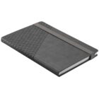 Closed black notebook with geometric cover design and elastic band, lying at an angle.
