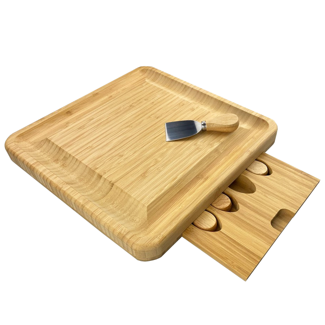 Madison Bamboo Cheese Board with metal spatula and slide-out tray cutouts.