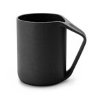 A sleek black mug with a modern design featuring a unique angular handle. The surface is smooth with a matte finish, giving it a contemporary look. The mug is empty and positioned against a plain white background.