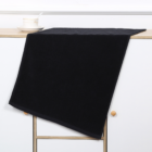 Gym towel draped on a white cabinet with a cup and saucer.