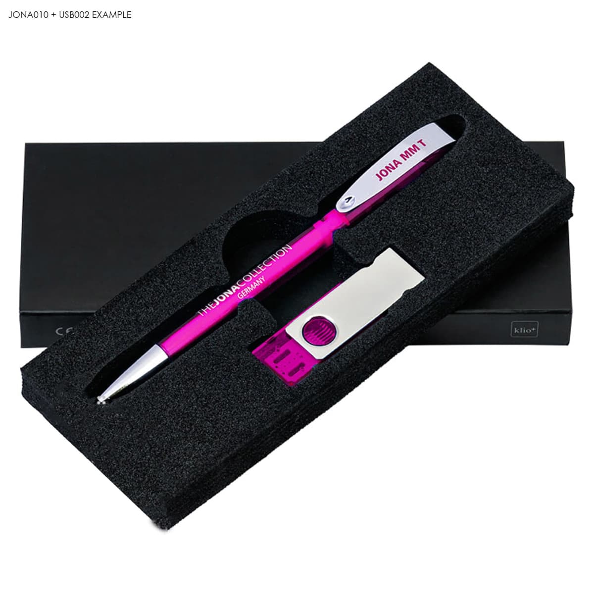 Pink pen and silver USB drive in a black foam gift box with a black lid.