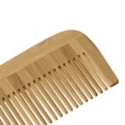 A close-up of a wooden comb with wide and narrow teeth.
