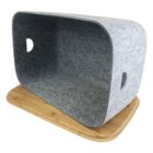 A gray felt cat cave with heart-shaped side cutouts, resting on a wooden base. The cave has an open front, providing a cozy space for pets.