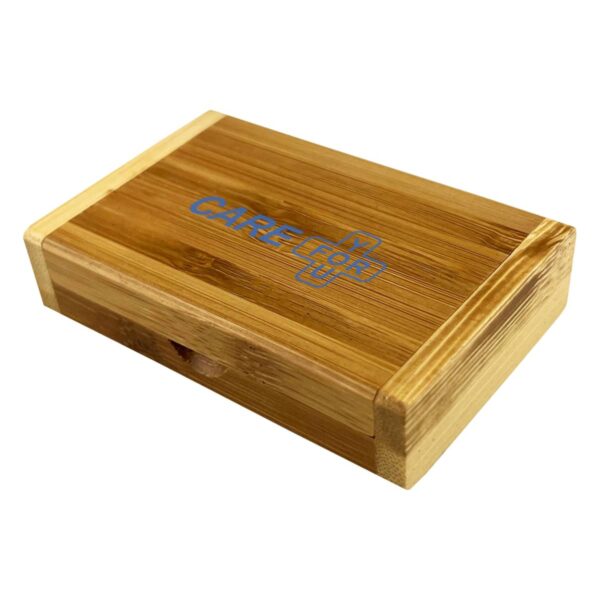 Rectangular wooden box with CARE and a blue medical cross symbol on the lid.