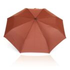 A fully-opened brown umbrella with a central black hub, displayed against a white background. Its surface is smooth and evenly spread out.