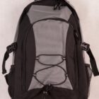 A black and gray backpack with multiple compartments. It features two side mesh pockets and a front bungee cord for additional storage. The backpack is placed against a neutral background.