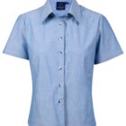 Light blue, short-sleeve button-up shirt with a classic collar and front pocket. The shirt has a simple, clean design and is displayed against a white background.