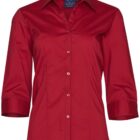 A red, long-sleeved button-up shirt with a collar, shown on a plain background. The shirt is made of a smooth fabric and is neatly folded.