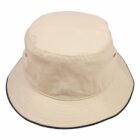 A beige bucket hat with a black trimmed brim is shown against a white background. The fabric appears soft, and there is a subtle stitching pattern visible along the brim.