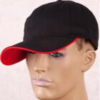 Mannequin head wearing a black baseball cap with a red trim on the visor.