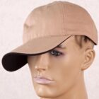 Mannequin head wearing a beige baseball cap with a slightly curved brim.