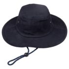 A black wide-brimmed hat with a chin cord and drawstring toggle. The hat has a flat top and metal eyelets on the sides for ventilation.