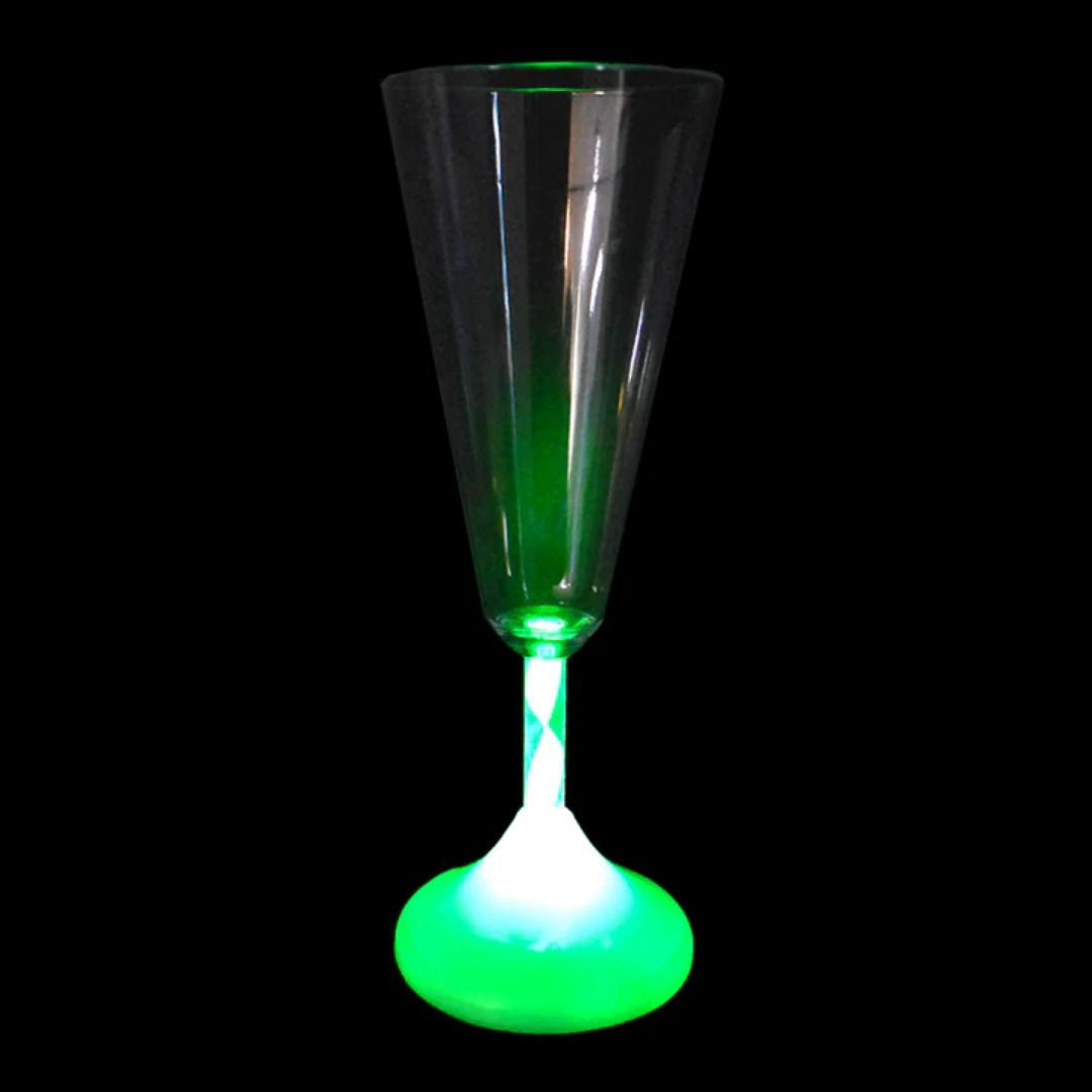 A Champagne Glass with Rainbow Light Colours amidst a black backdrop.