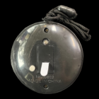 Christmas Tree Medallion Necklace: Black, textured, buttoned device with attached string.