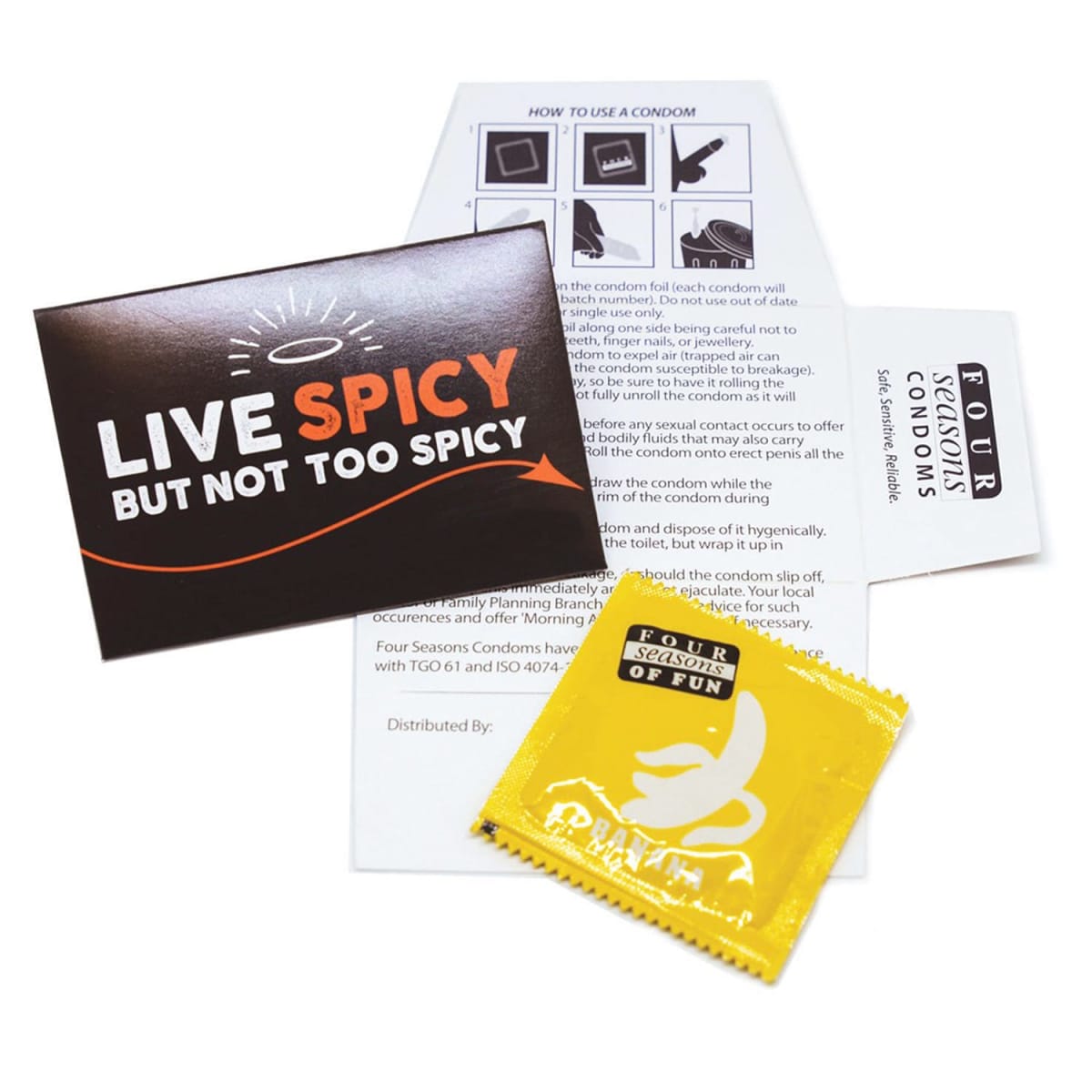 A condom package titled Live Spicy But Not Too Spicy is shown with an open informational pamphlet on condom use. The package includes a yellow condom wrapper labeled Four Seasons Condoms.