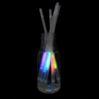 Glow Straws x 6 float in a bottle of water against a black background.