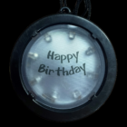 Birthday Medallion Necklace glows with bright LED colors and Happy Birthday text.