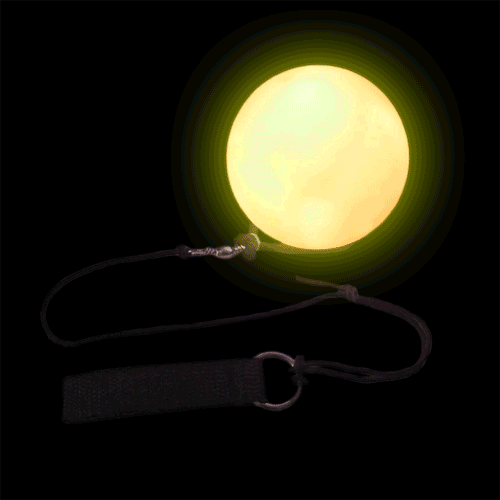 The Multi-function LED Poi Ball glows brightly with its black strap in the dark.
