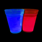 Two Neon Glow Cups from set of four, one blue and one red, against a black background.
