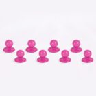 Eight pink suction cups on a white background.