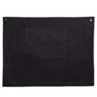 Black fabric with a central pocket and two corner grommets.