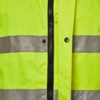 Close-up of a bright yellow jacket with reflective silver stripes and black buttons. The jacket features a partially zipped front, showcasing a snap button closure along the zipper line.