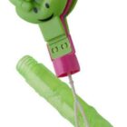 A green hand-shaped clapper toy with a smiling face and pink accents. It has a pink handle and is connected to a green plastic base by a string.