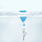 Key on a ring floating underwater attached to a blue float.