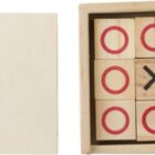 Wooden tic-tac-toe game with X and O pieces beside a square lid.