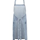 Light blue denim apron with adjustable neck strap and long waist ties. Features two large front pockets with button details. The apron has a vintage, casual style.