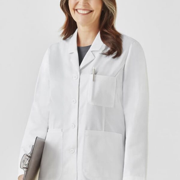 A person in a white lab coat smiles, holding a clipboard.