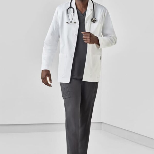 A doctor in white coat and stethoscope stands smiling against a plain background.