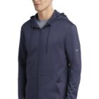 Man wearing a navy blue zip-up hoodie with a small Nike logo on the sleeve.
