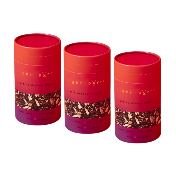 Three red-orange canisters labeled Tiger Purrr Chai Tea Gift Sets.