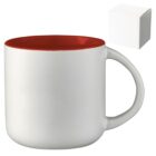 A white ceramic mug with a red interior and a large handle is shown. In the corner, theres a small white box, possibly the mugs packaging.