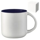 White ceramic mug with a navy blue interior, featuring a large handle. Next to the mug is a small white box, possibly the packaging. The mugs design is simple and modern.