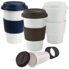 Four reusable coffee cups with colored lids and sleeves in blue, black, and white.