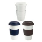 Three reusable coffee cups with lids and grip bands in white, navy blue, and brown colors.