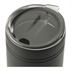 A close-up of a stainless steel travel mug with a transparent plastic lid. The lid features a small drinking hole and a larger sip opening, designed to prevent spills. The mug has a sleek, matte finish with two subtle horizontal ridges.