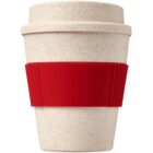 A reusable cream-colored bamboo coffee cup with a solid red silicone sleeve around the middle. The cup has a lid, matching the cream color, and a minimalist design.