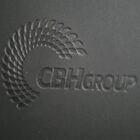 Embossed black surface featuring a spiral pattern of dots forming a crescent shape and the text CBH Group in bold, modern typography.
