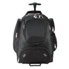 A black rolling backpack with multiple zippered compartments is pictured, featuring a retractable handle on top and wheels at the bottom, designed for easy transportation.