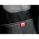 Close-up of a black fabric bag featuring a mesh section at the top and a small red tag with a white symbol.
